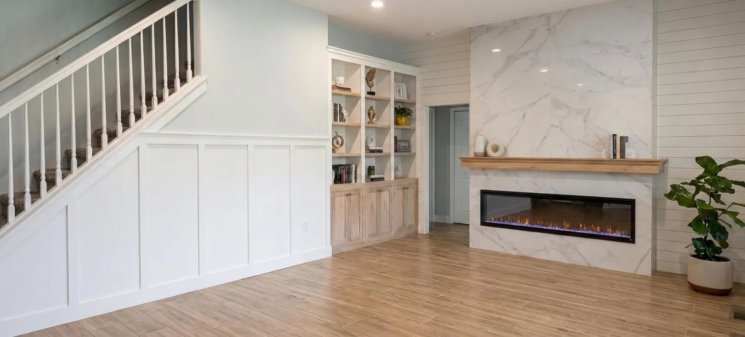 Custom living-room built-ins with a porcelain fireplace surround and shiplap accent wall